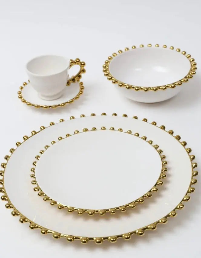 The Gold Beaded Dinner Set is a luxurious and opulent collection that transforms ordinary dining into a regal experience. Crafted with meticulous attention to detail